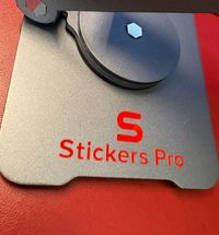 Pegatina de metal color rojo sobre soporte tableta